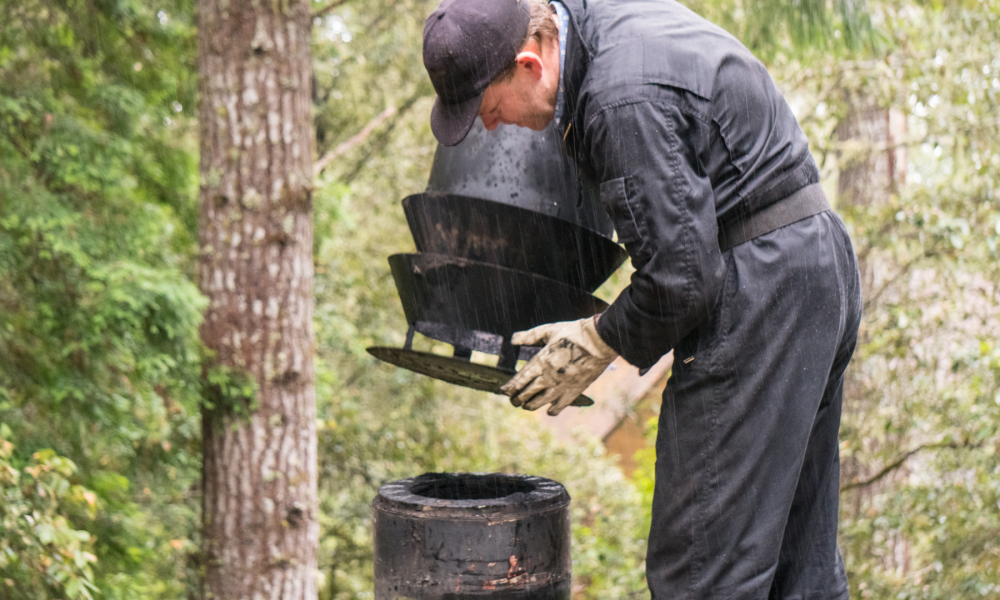man reattaching chimney cap to chimney
