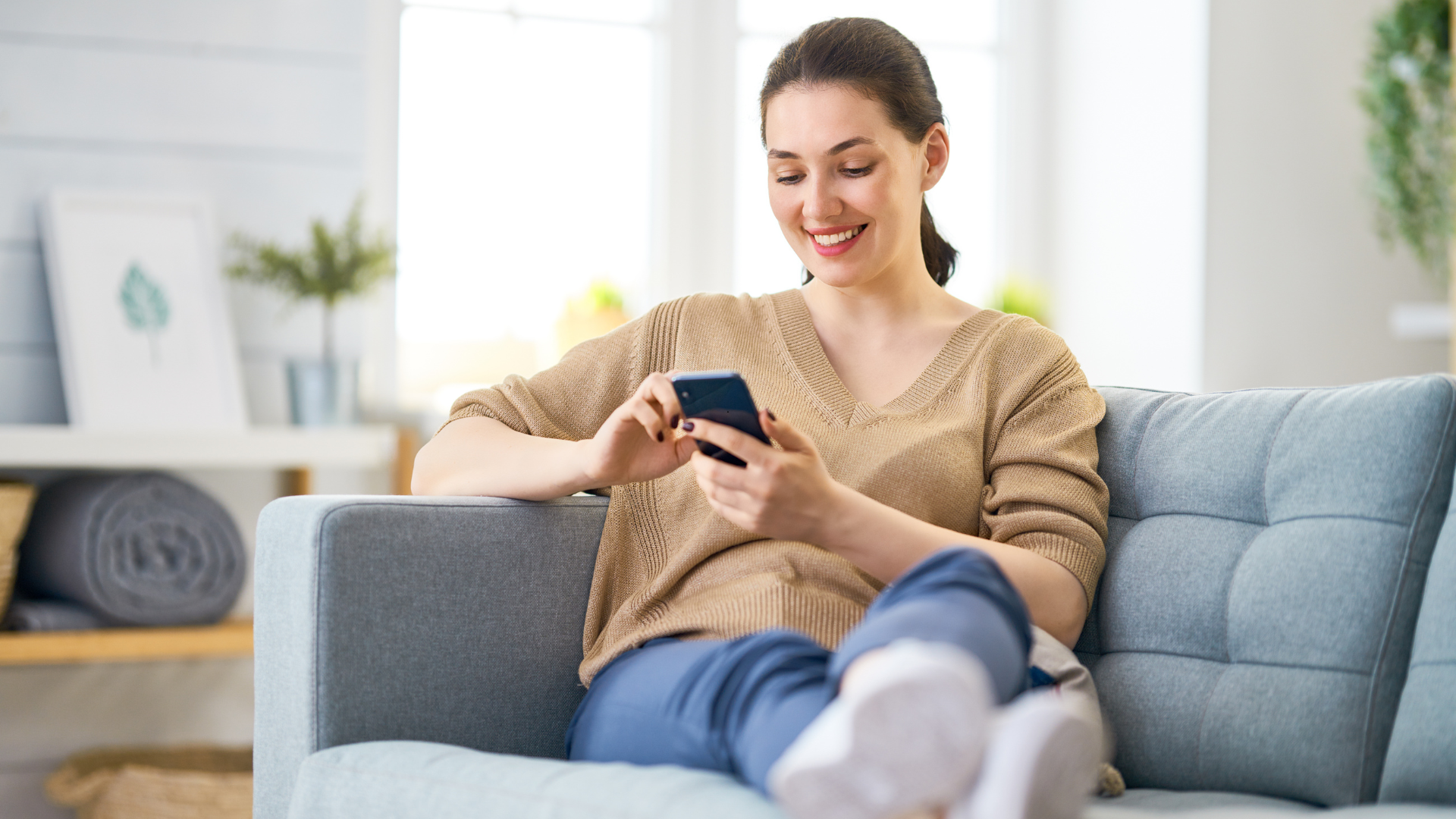 woman sitting at home on cell phone