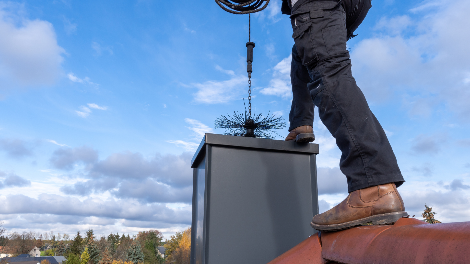 close up of chimney sweep tool going down chimney