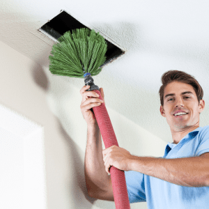 Tech cleaning vent Air conditioning vent cleaning technician inserting cleaning probe into vent.